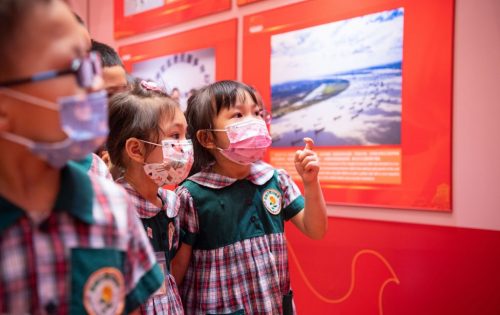Children visit the photo exhibition celebrating the 100th anniversary of the founding of the Communist Party of China - Photo by Cheong Kam Ka