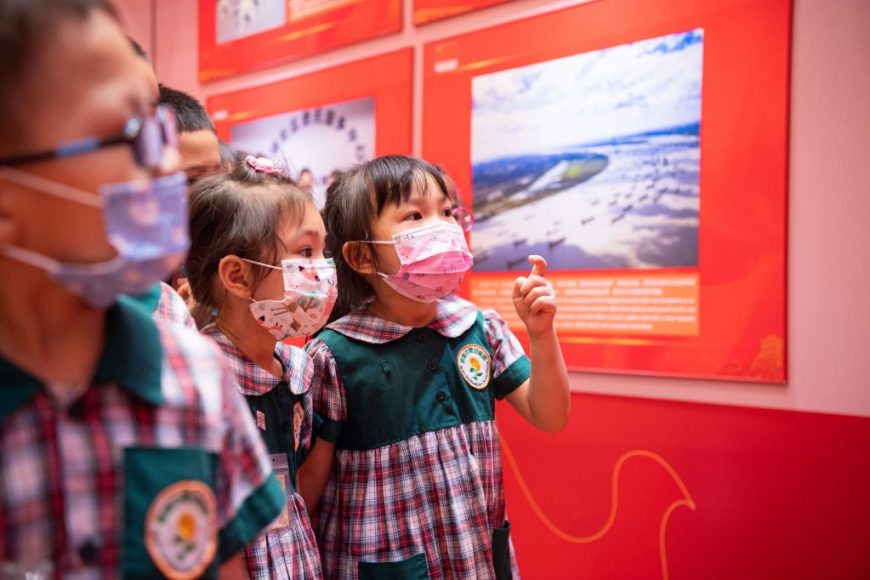 Children visit the photo exhibition celebrating the 100th anniversary of the founding of the Communist Party of China - Photo by Cheong Kam Ka