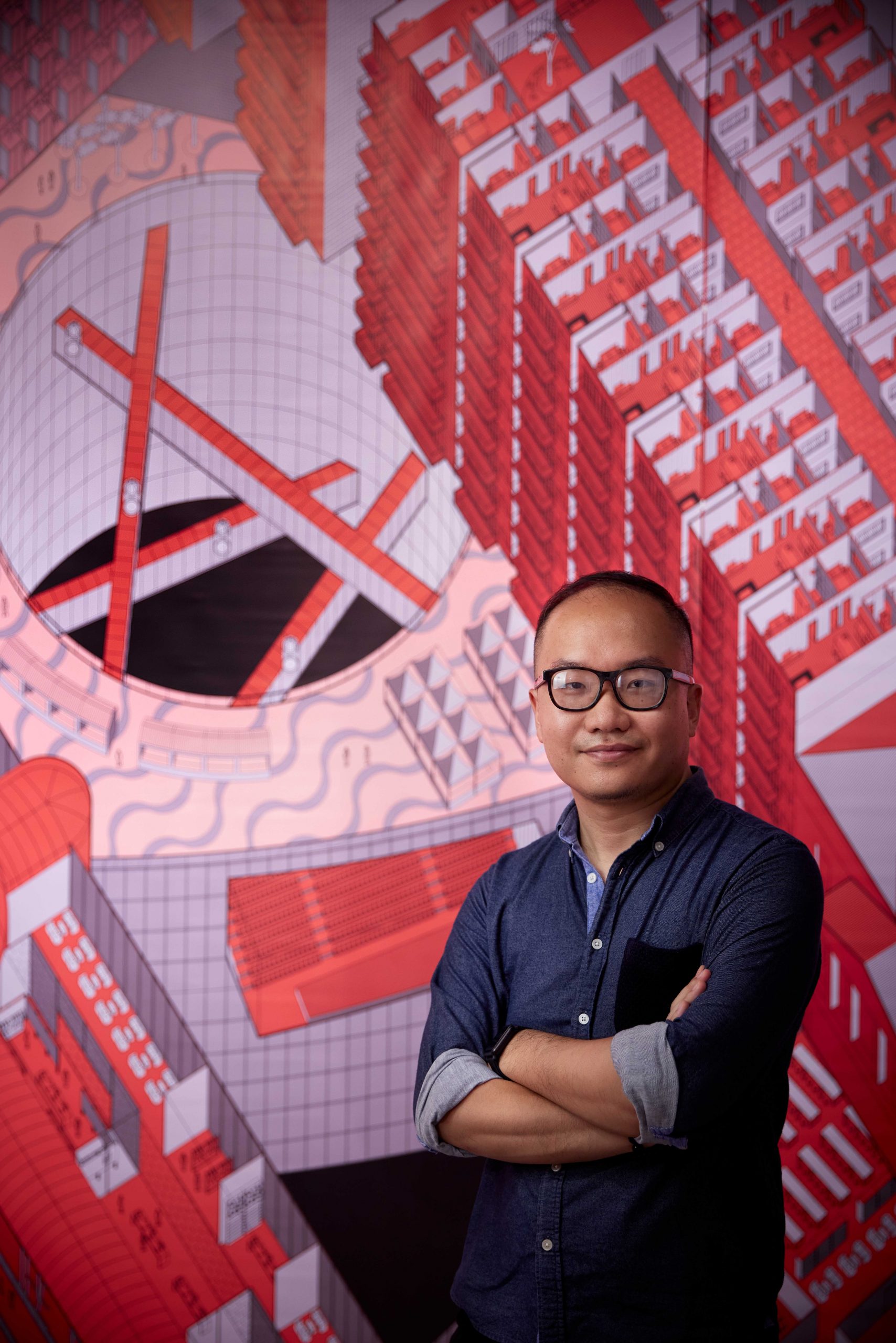 Daniel Ho Ting Fong in front of his floor-to-ceiling digital drawing in his 'Boundary Verticalisation – the Collision of Two Different Urban System' exhibition