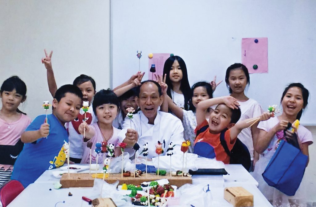 Lam and his students happily show off their dough sculptures