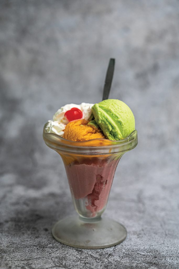 Four scooped flavoured ice cream with coconut, mango, strawberry and peppermint