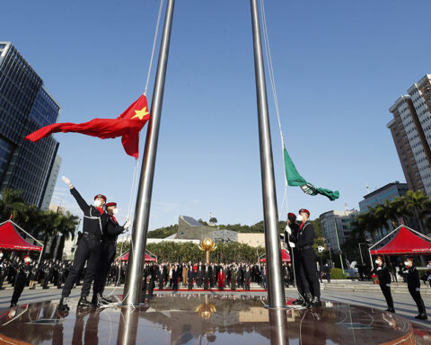 A flag-raising ceremony at Golden Lotus Square commemorates the anniversary