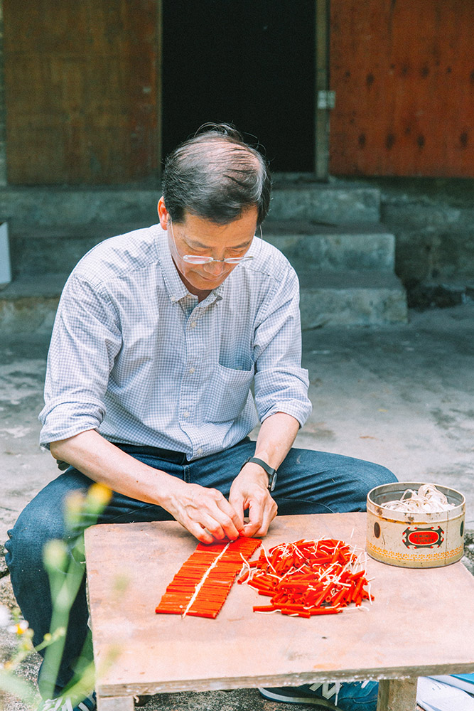Lai demonstrates firecracker braiding – a craft he did as a child – inside the Iec Long premises