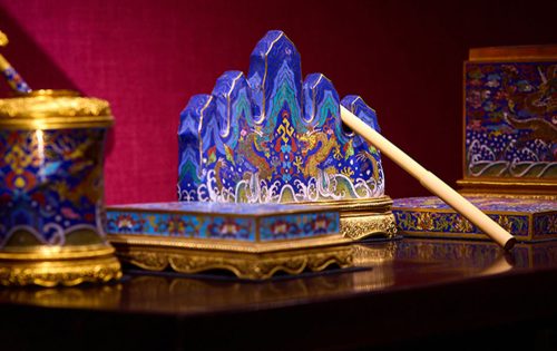 Expertly rendered sea wave, cloud and dragon patterns decorate this cloisonné enamel water pot, dating from the Qianlong reign (1736-1795)