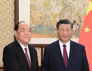 President Xi Jinping (right) welcomes Chief Executive Ho Iat Seng to Beijing