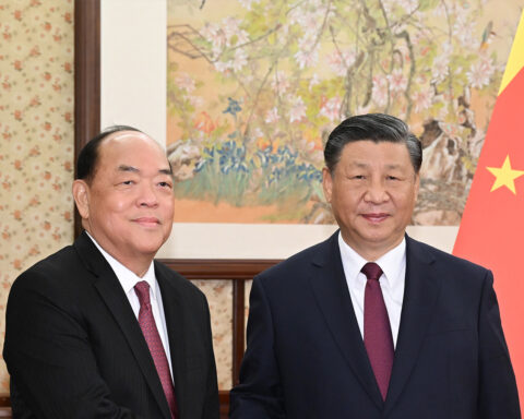 President Xi Jinping (right) welcomes Chief Executive Ho Iat Seng to Beijing