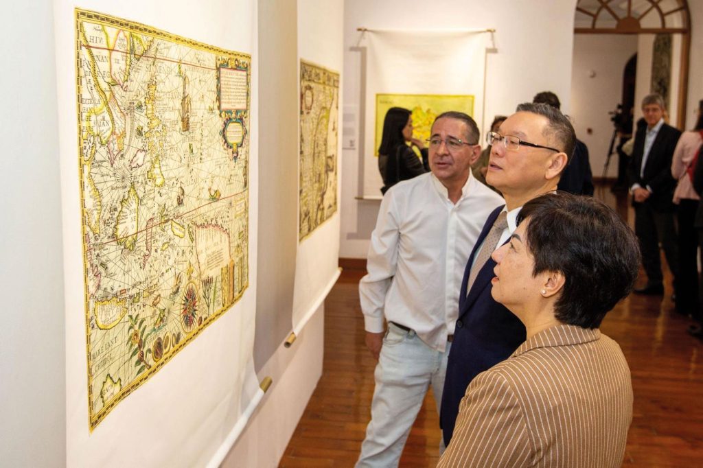 Exhibition-goers admiring the large-scale reproductions of historic maps
