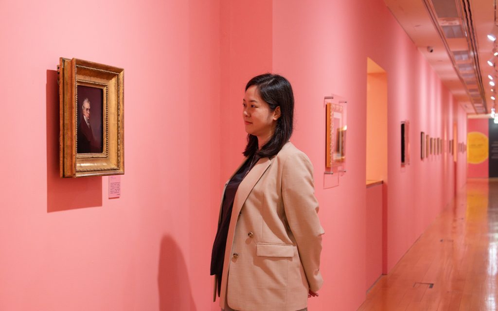 Un Sio San, director of the Macao Museum of Art, admires a copy of a George Chinnery self-portrait by Canton painter Lam Qua