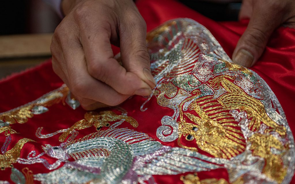 Each painstakingly hand-stitched element adds a layer of meaning to the garment