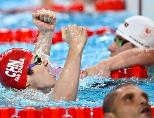 Olympic swimmer Pan Zhanle waves to attendees in Macao, fresh from his gold medal-winning performance in Paris