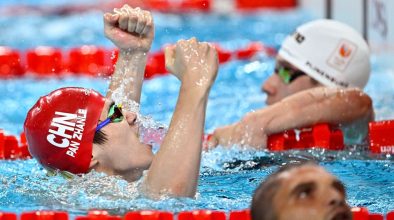 Olympic swimmer Pan Zhanle waves to attendees in Macao, fresh from his gold medal-winning performance in Paris