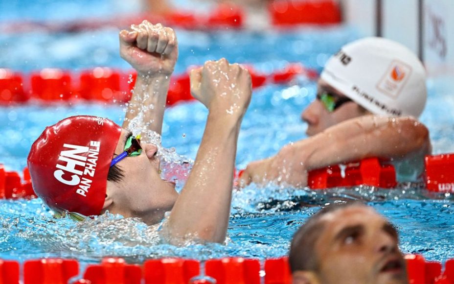 Olympic swimmer Pan Zhanle waves to attendees in Macao, fresh from his gold medal-winning performance in Paris