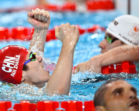 Olympic swimmer Pan Zhanle waves to attendees in Macao, fresh from his gold medal-winning performance in Paris