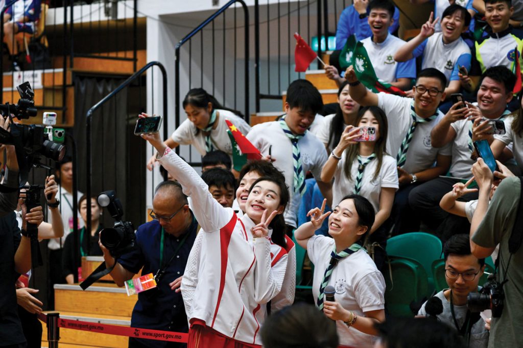 The Chinese Olympians posed for selfies with young students from Macao