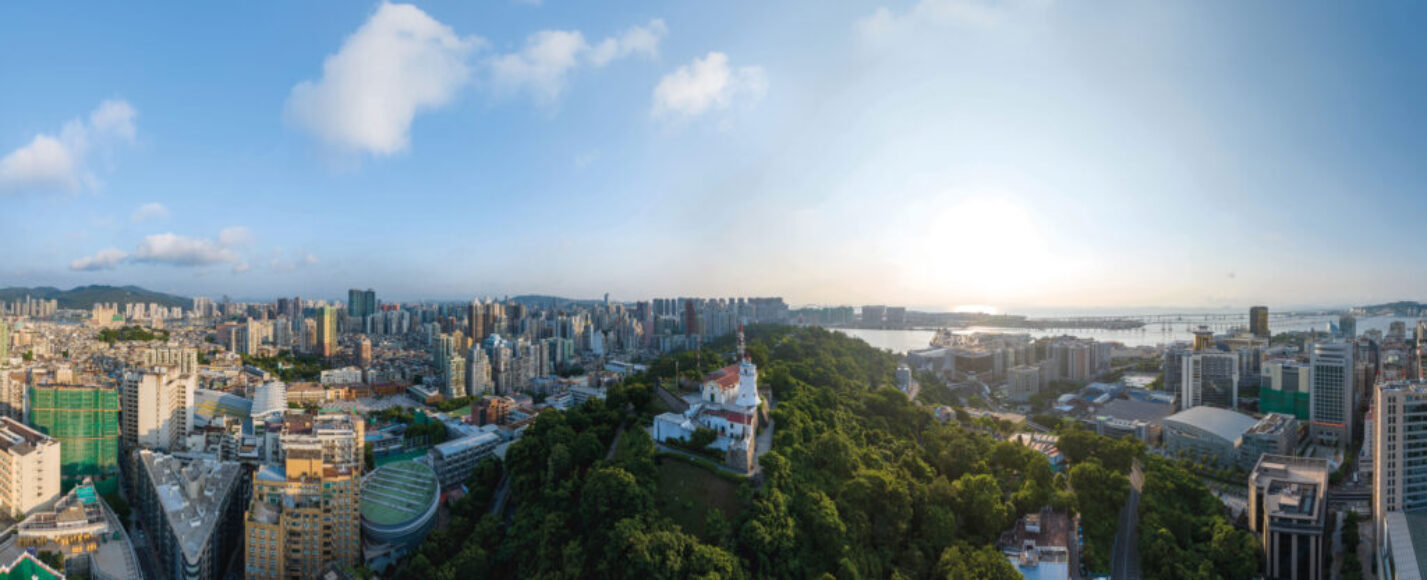 A 17th-century fort looks out from the dense green of Guia Hill to the busy, modern city below