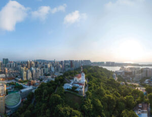 A 17th-century fort looks out from the dense green of Guia Hill to the busy, modern city below