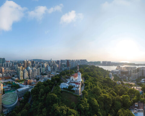 A 17th-century fort looks out from the dense green of Guia Hill to the busy, modern city below