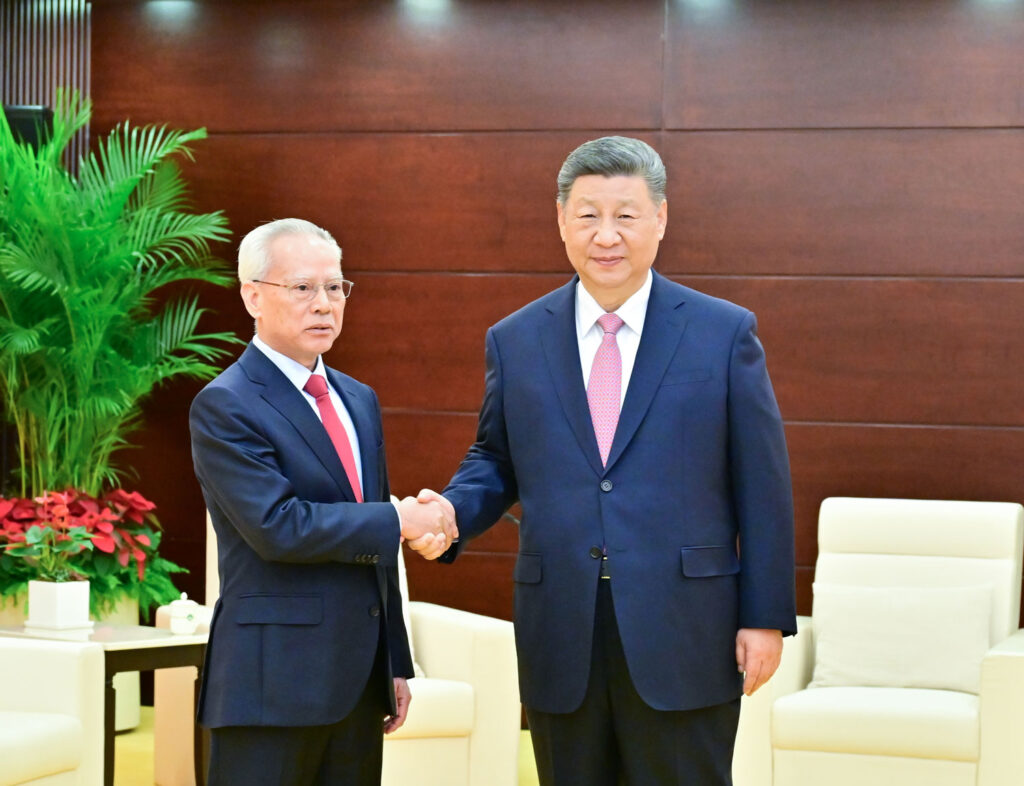 President Xi Jinping shakes hands with Macao’s newly minted chief executive after swearing Sam Hou Fai into office