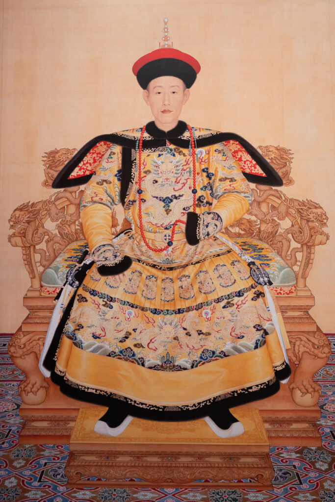 The exhibition features several portraits of Emperor Qianlong, including this intricately detailed depiction of him in an embroidered robe