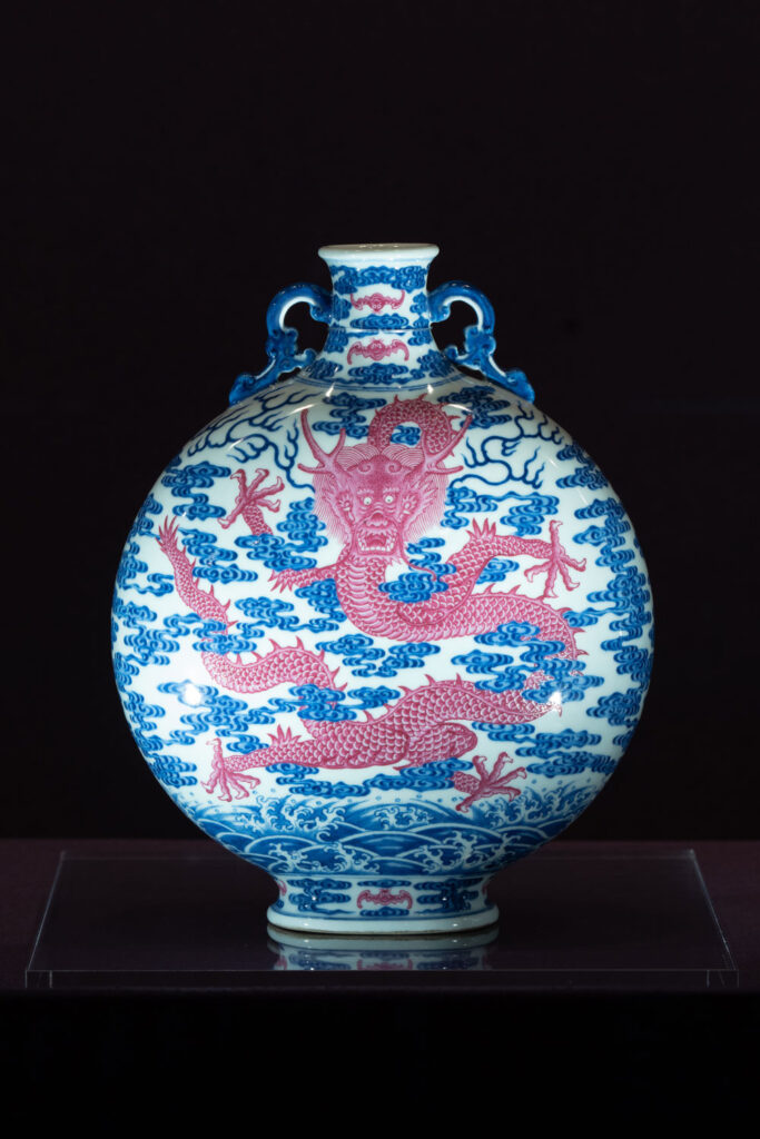 A bianhu (moon flask) delicately painted with a dragon amidst clouds, made during Emperor Qianlong’s reign