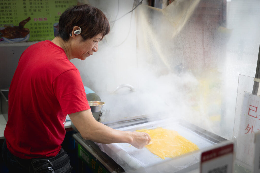 Lam at work in his steamy kitchen