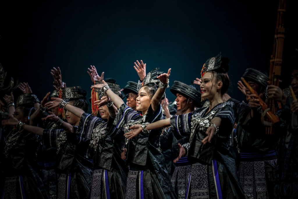 Performers dressed in traditional Miao garments from southwestern China. Clothing items in this style are known as “wearable history books”