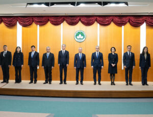 The 10 principal officials of Macao’s sixth-term government stand on stage at their inauguration ceremony, with Chief Executive Sam Hou Fai at their centre