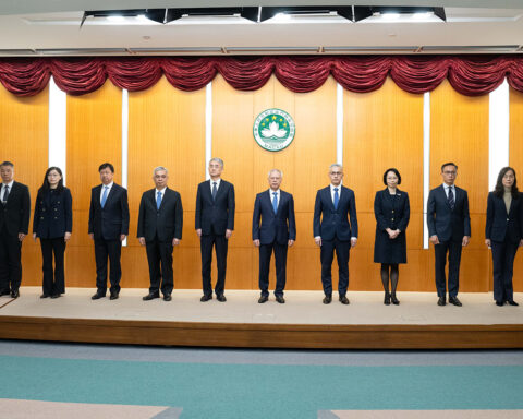 The 10 principal officials of Macao’s sixth-term government stand on stage at their inauguration ceremony, with Chief Executive Sam Hou Fai at their centre