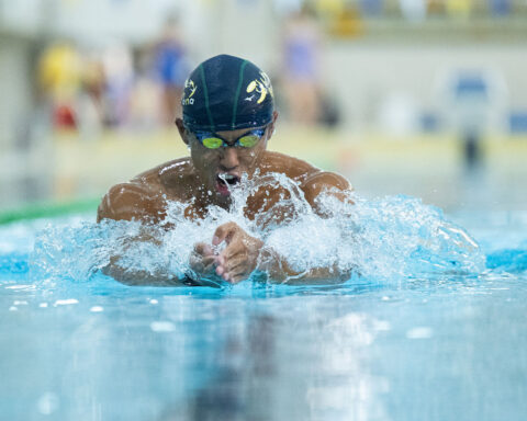 Chao Man Hou takes a breath as he surges through the water in his signature breaststroke