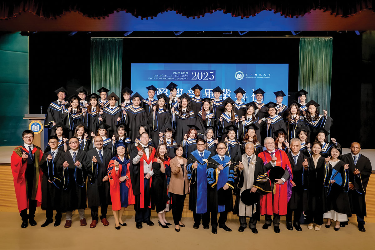 A happy graduation day: The Class of 2025, along with some faculty members, beam from up on stage