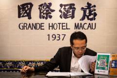 A receptionist sits beneath a sign proclaiming the date that construction began on the Grande Hotel