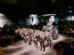 A horse-drawn chariot that was excavated in 1980 on display at the Mausoleum of the First Qin Emperor. With an umbrella-like canopy, this chariot – which is not a replica – was historically used in battle or on tours of inspection.