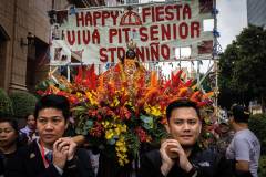 Two members of the Sinulog Festival’s organising committee help carry a litter with a figure of the Infant Jesus through the streets of Macao
