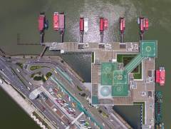 A unique aerial view of the Macau Outer Harbour Ferry Terminal. An array of ferries are in the dock, waiting to head off to Hong Kong and other locations.