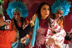A member of the Orient Premier Tribe dance troupe arranges the hair of the group’s queen before festivities begin