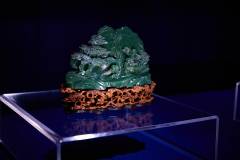 Perched on a delicate wooden base, this carved jasper shanzi (a traditional mountain sculpture) from the Qing dynasty depicts children at play 