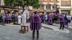 A young woman takes on the role of Veronica, who used her veil to wipe the sweat from Jesus’s brow as he carried the cross