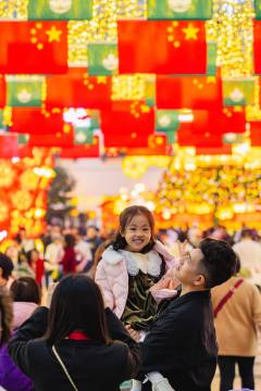 The festivities drew crowds young and old to celebrate in the glittering streets of Macao